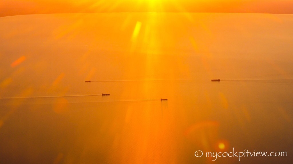 Mycockpitview. Boats crossing eachother between Danemark and Sweden. The sunset turning water into gold.